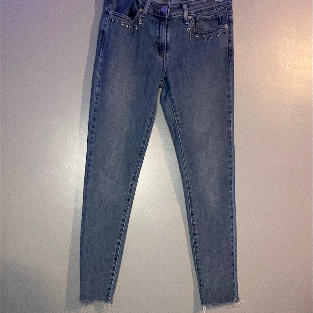 Light wash Levi’s skinny jean with metal details